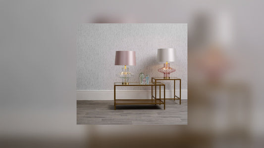 Clear glass table lamp glowing warmly in a cosy room ready for Christmas