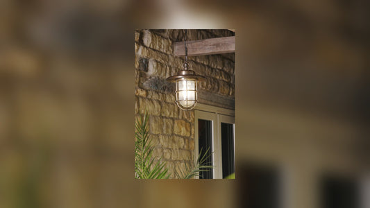 Outdoor wall lantern lighting a front door at dusk