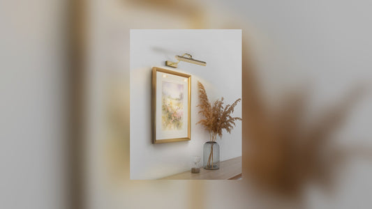 Brass picture light illuminating a framed painting in a living room