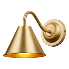 A bathroom wall light with a circular backplate finished in a golden butter brass, from the back plate a curved arm comes off to hold a cone shaped shade which fans out from the arm pointing downwards