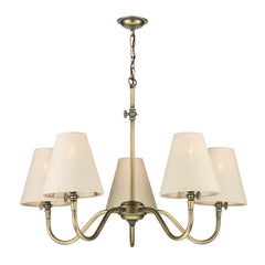 5 lighting chandelier finished in antiqe brass with a neat ceiling rode plus a chain hanging to the main light fitting, it is shown with linen shades in a light neutral colour that are not included in the price, the shades can be ordered separately. The chandelier has a gas lamp button detail on the side of each arm representing old retro style lights.