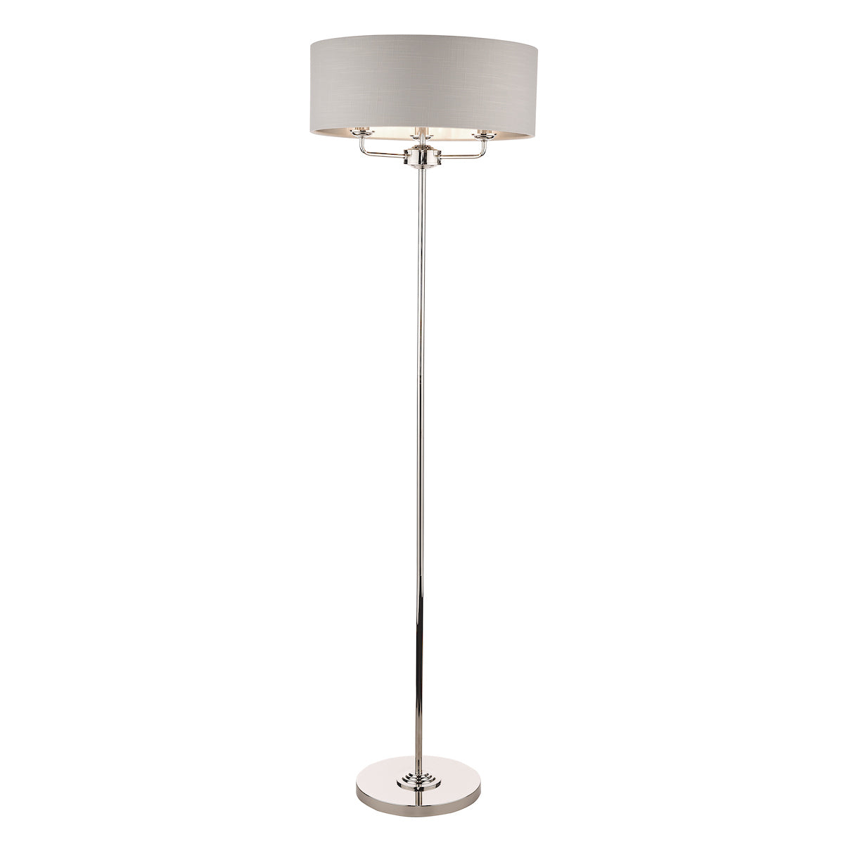 A heavy based metal floor lamp finished in reflective polished nickel, with a silver grey shallow drum shade, that surrounds the top bulb holder which frame is partially visible peeking beneath the shade, the light has three bulbs on a frame with arms inside the shade so it makes it a very bright light if required.