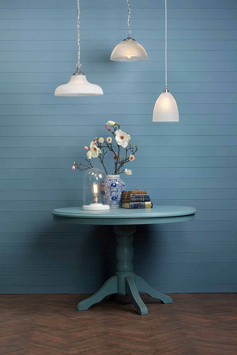 Double insulated David Hunt Badger bronze pendants hanging above a console table in a blue painted period room